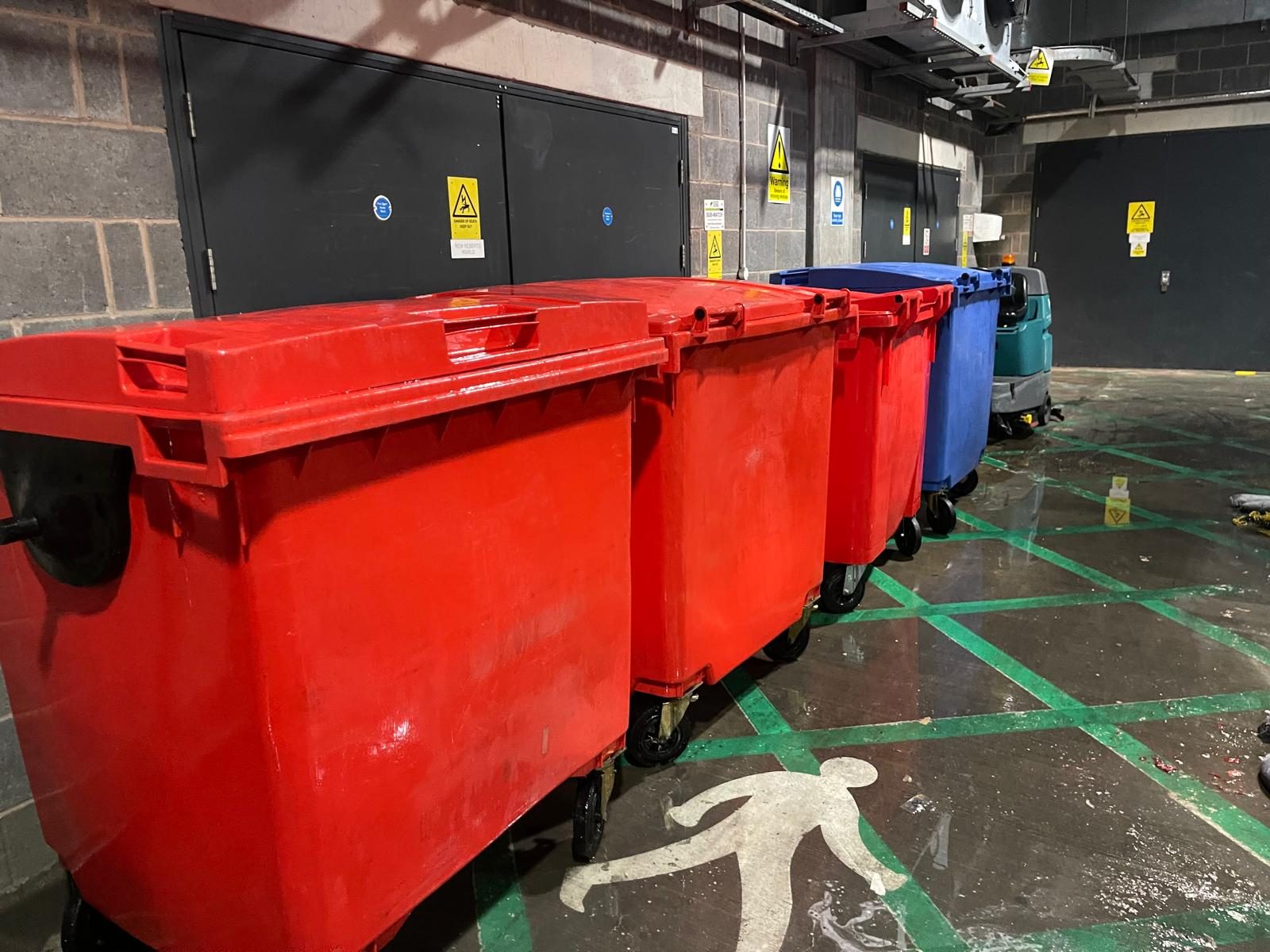 A BinFresh operative deep-cleaning a commercial wheelie bin